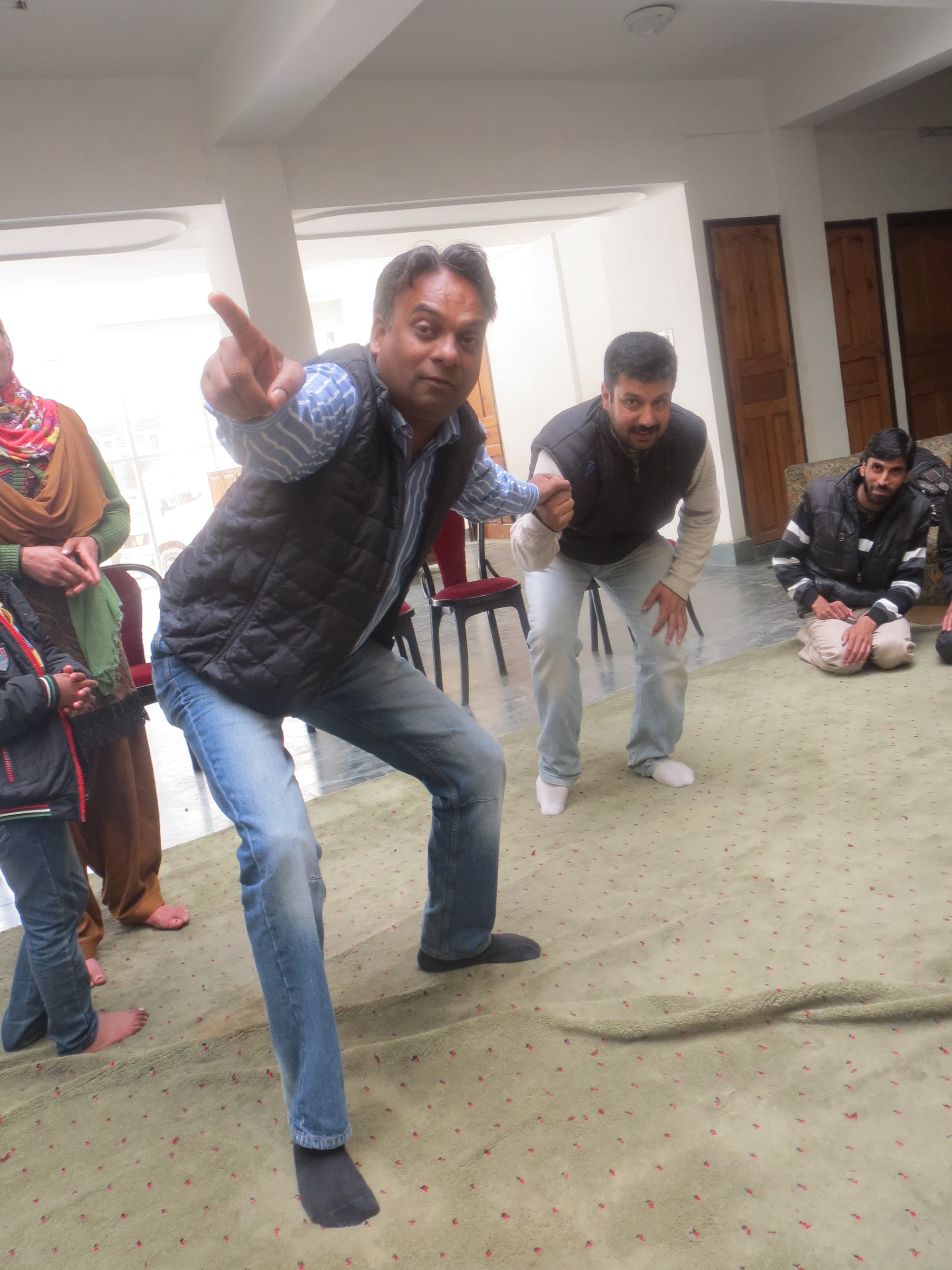 A trainer leading a room of women participants at a KOSHISH peer leader training workshop