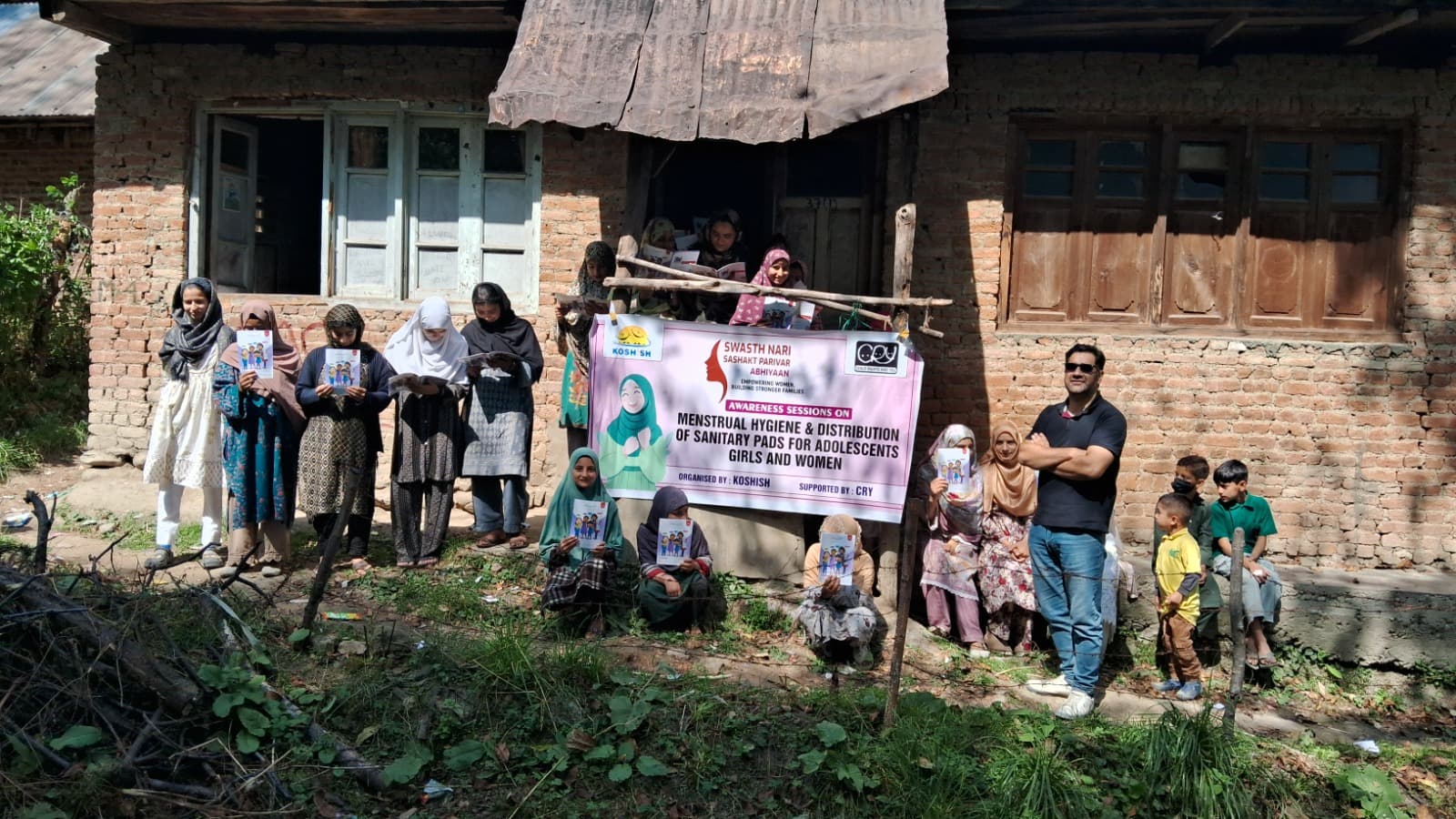 Adolescent girls and women receiving information at a KOSHISH menstrual hygiene awareness session